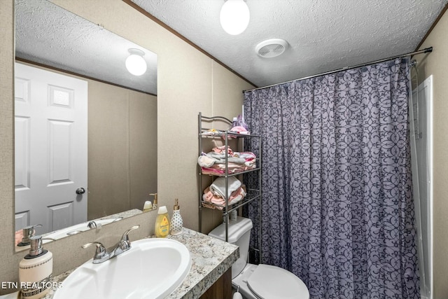 bathroom with vanity, a textured ceiling, and toilet