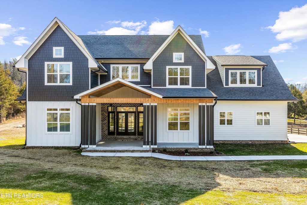 rear view of house featuring a yard and french doors