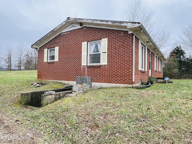 view of side of home with a lawn