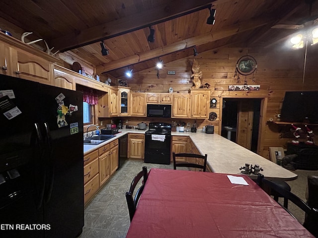 kitchen with sink, vaulted ceiling with beams, black appliances, wooden walls, and wood ceiling