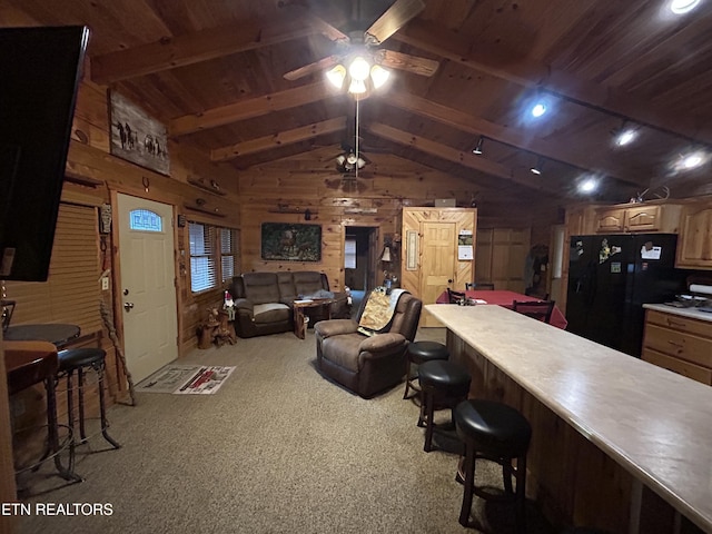 living room featuring vaulted ceiling with beams, wood walls, wood ceiling, and light carpet