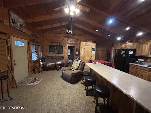 living room featuring wood ceiling, vaulted ceiling with beams, wood walls, and light colored carpet