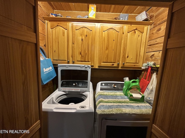 washroom featuring cabinets and separate washer and dryer