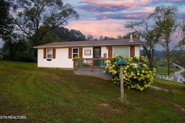 ranch-style home with a lawn