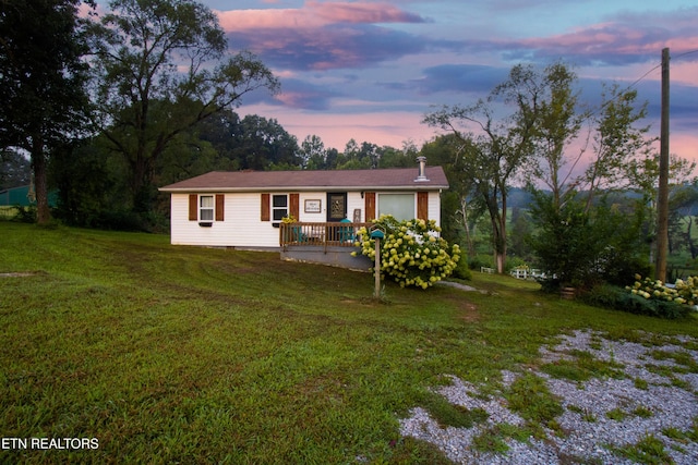 ranch-style house with a yard