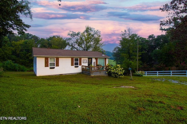 view of front of house featuring a yard and a deck