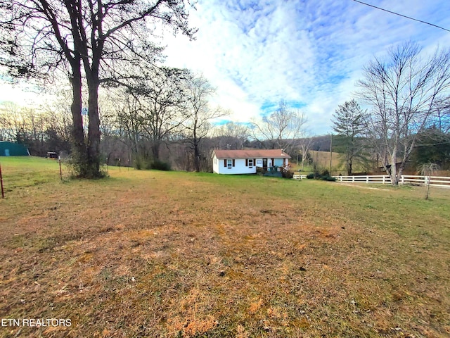 view of yard with a rural view and an outdoor structure