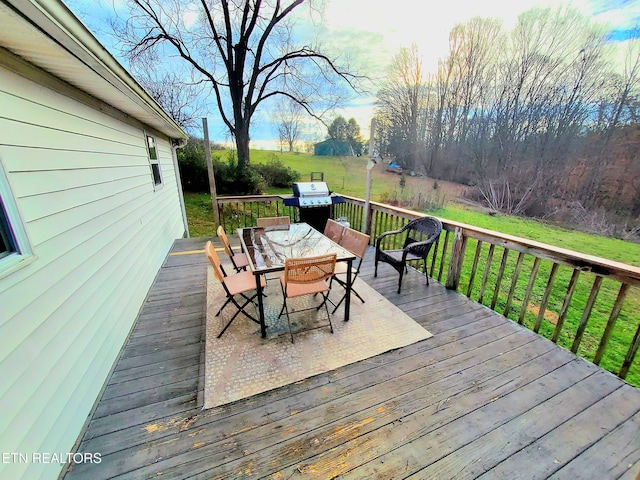 wooden terrace featuring a yard and grilling area