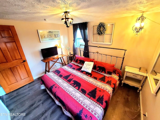 1471 Harold Patterson Rd, Dandridge, TN 37725 - bedroom featuring a chandelier, a textured ceiling, and wood finished floors
