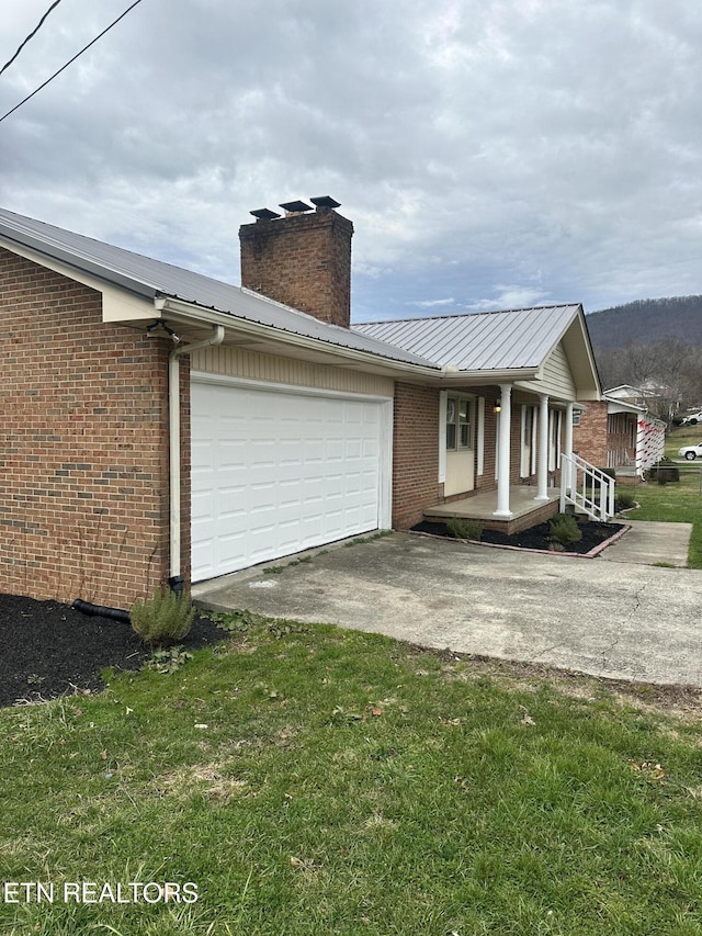 view of side of home with a garage and a yard