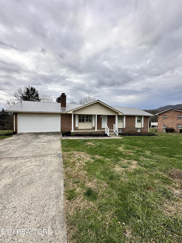 single story home with a front yard, a garage, and covered porch