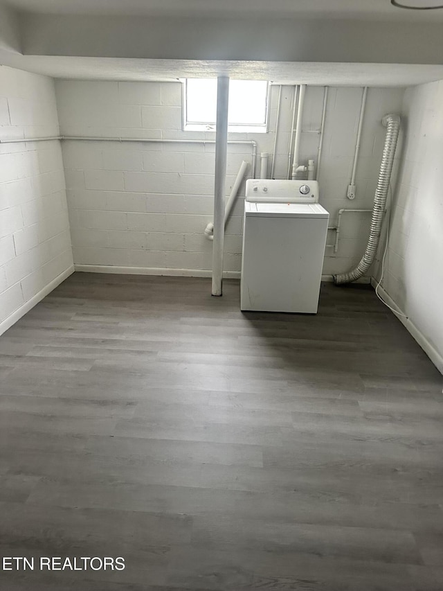 basement with washer / clothes dryer and wood-type flooring