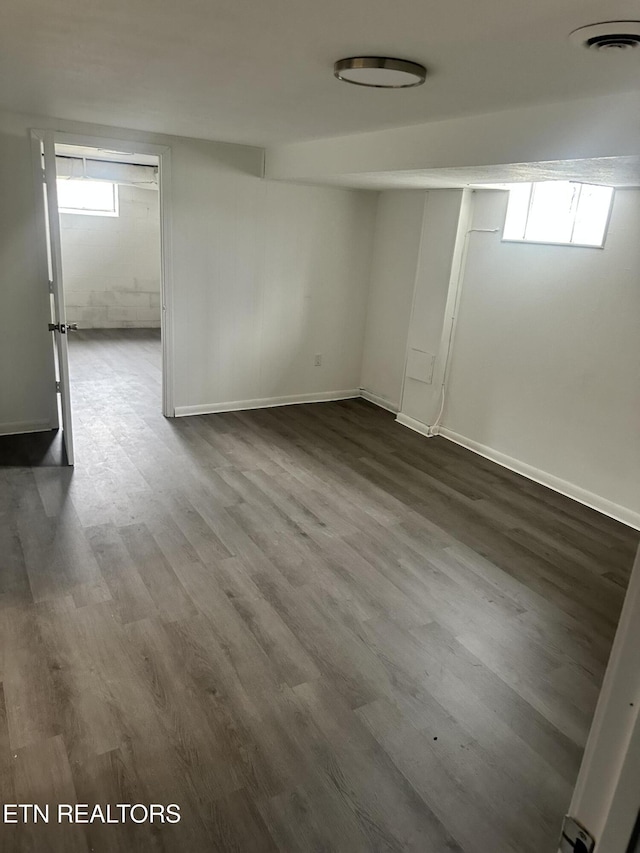 spare room with plenty of natural light and hardwood / wood-style flooring