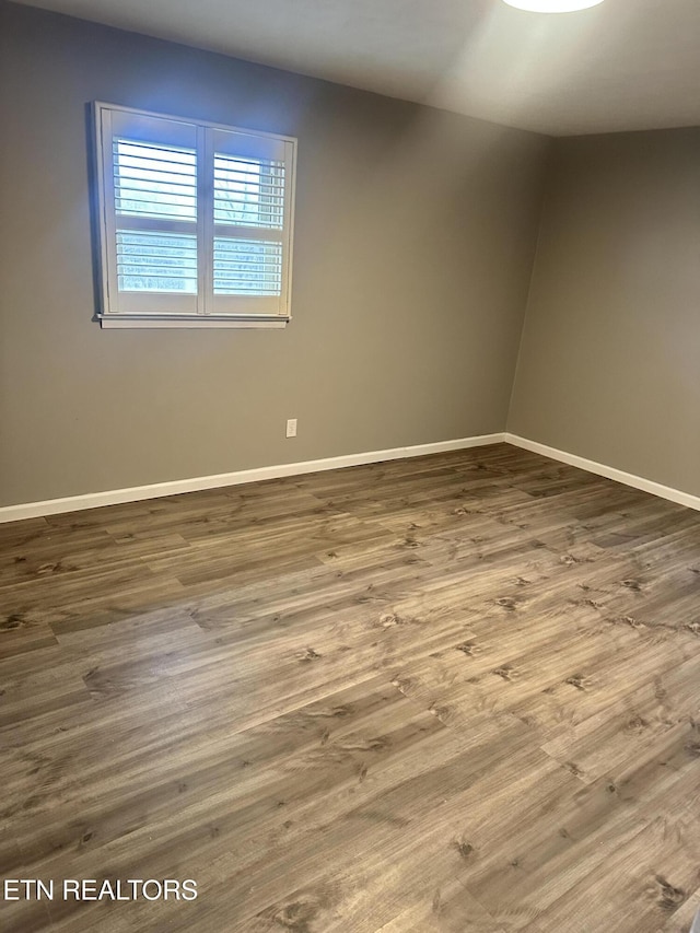 spare room featuring hardwood / wood-style flooring