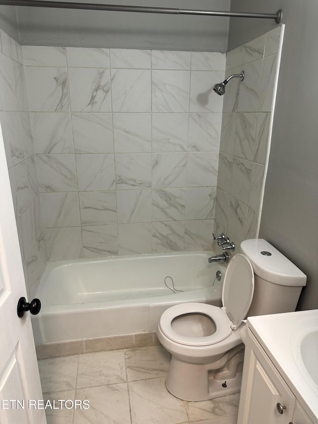 full bathroom with toilet, vanity, and tiled shower / bath combo