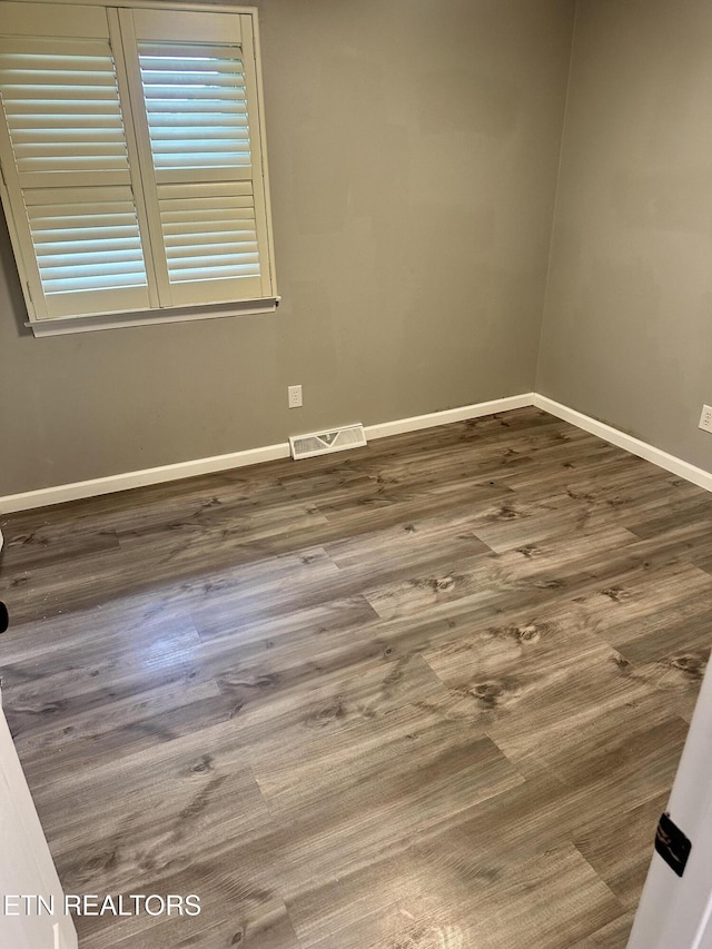 empty room featuring dark wood-type flooring