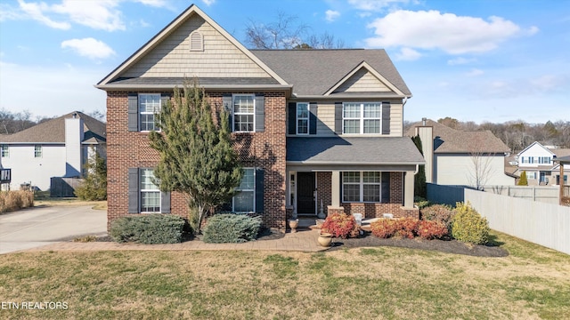 view of front facade with a front yard and covered porch