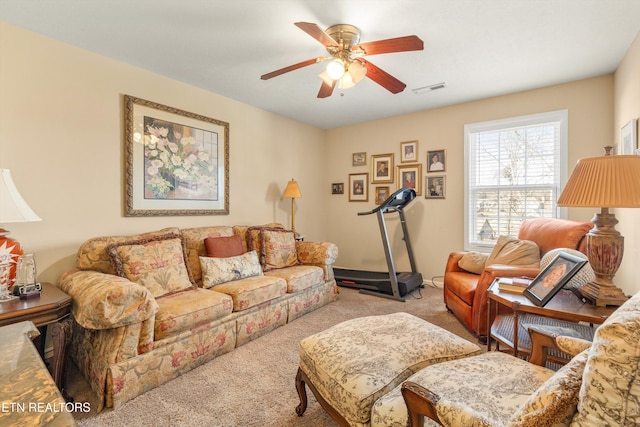 living room featuring light colored carpet and ceiling fan