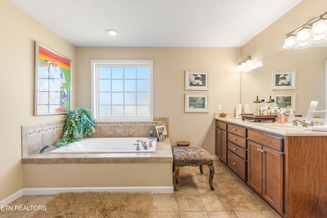 bathroom with tile patterned flooring, vanity, and a bathing tub