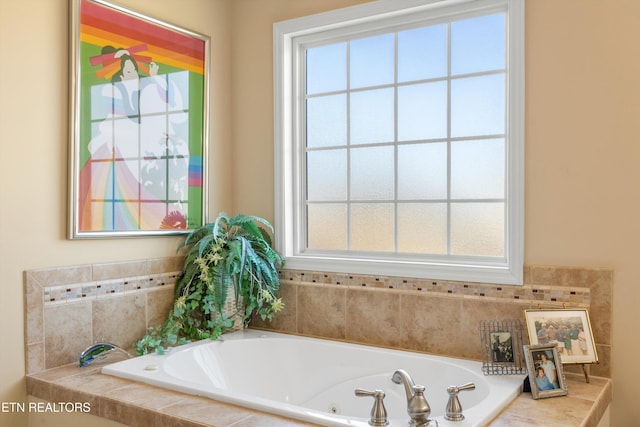 bathroom with a healthy amount of sunlight and tiled tub