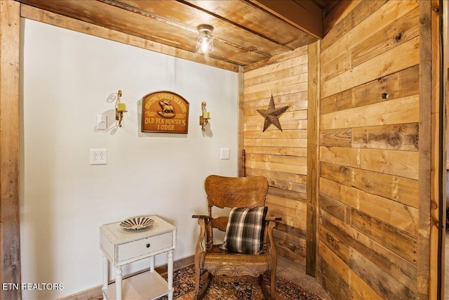 sitting room featuring wood walls and wood ceiling