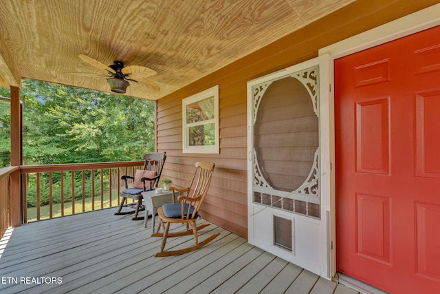 wooden deck with covered porch and ceiling fan