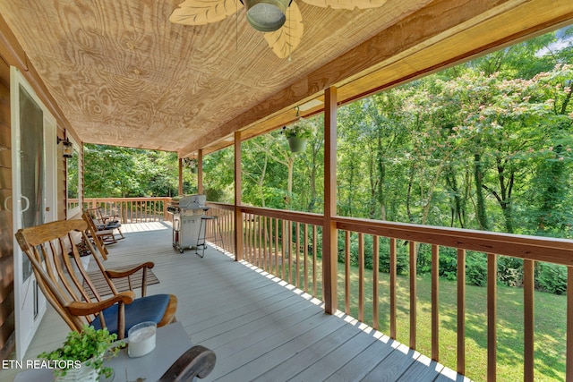 wooden terrace featuring a lawn, area for grilling, and ceiling fan