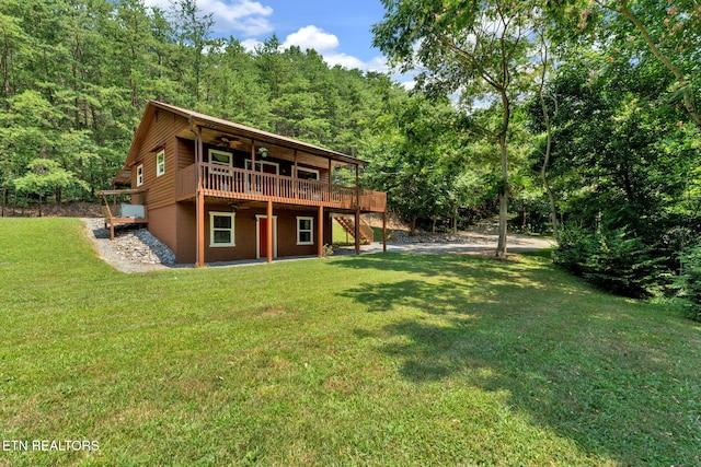 back of house with a lawn and a wooden deck