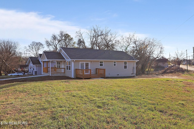 back of property featuring a deck and a yard