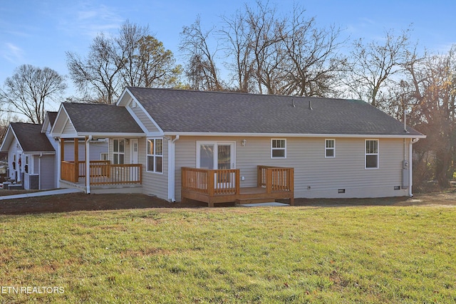 back of property featuring central AC unit, a wooden deck, and a lawn