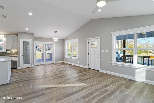 unfurnished living room featuring ceiling fan, plenty of natural light, and light hardwood / wood-style flooring