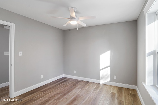 empty room featuring ceiling fan and hardwood / wood-style flooring