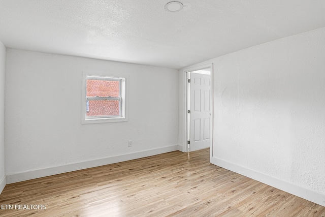 spare room featuring light hardwood / wood-style flooring