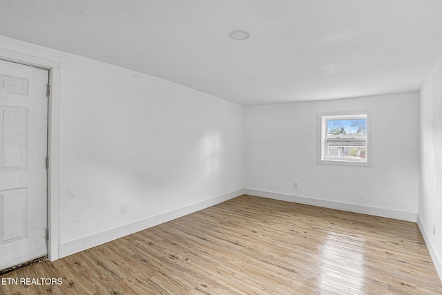 unfurnished room with light hardwood / wood-style flooring