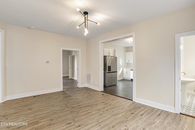 interior space featuring light hardwood / wood-style floors and an inviting chandelier