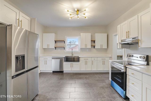 kitchen featuring a notable chandelier, sink, white cabinetry, and stainless steel appliances