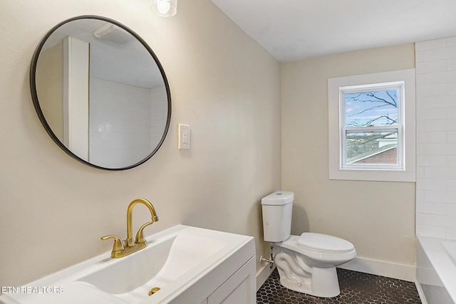 bathroom featuring tile patterned flooring, vanity, and toilet