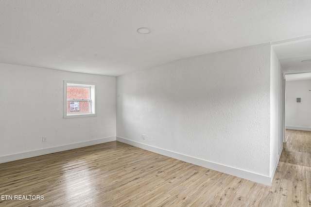 empty room with light hardwood / wood-style flooring