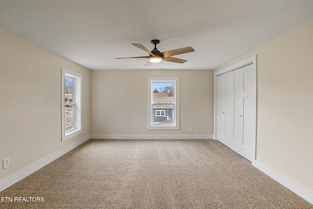 unfurnished bedroom with carpet flooring, ceiling fan, and a closet