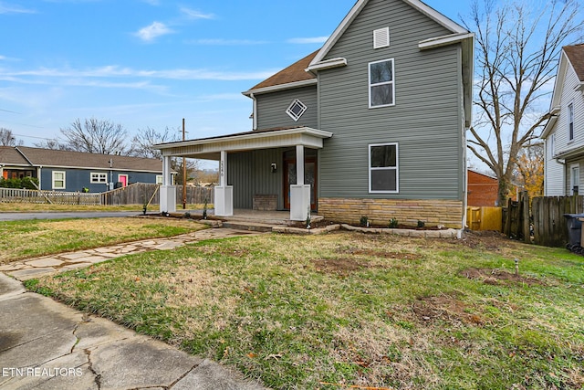 view of property featuring a front yard and a porch