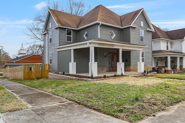 view of front of house with a front yard and a porch