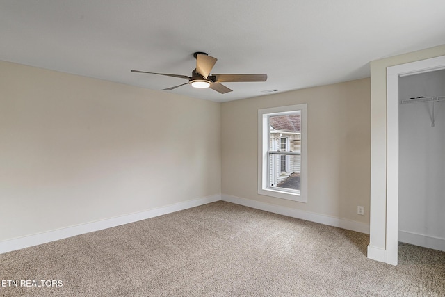 unfurnished bedroom with carpet, a closet, and ceiling fan