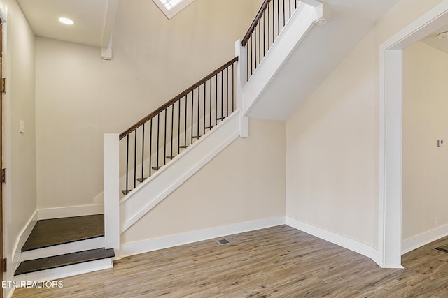 stairs with hardwood / wood-style flooring