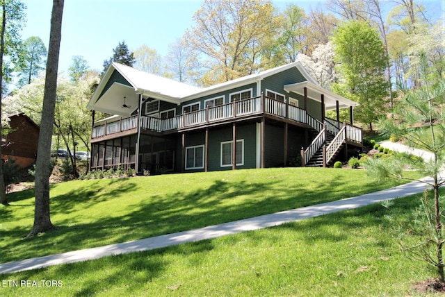 rear view of house with a lawn and a deck