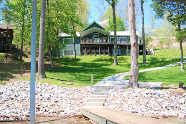 back of house with a yard and a deck