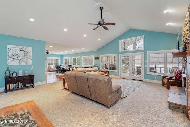 carpeted living room featuring ceiling fan and vaulted ceiling