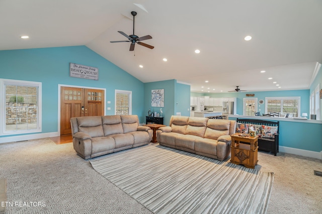 living room featuring ceiling fan, lofted ceiling, and light carpet