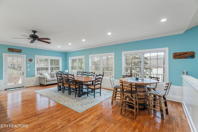 dining area featuring light hardwood / wood-style flooring, ceiling fan, and ornamental molding