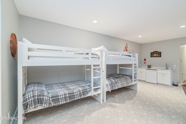 carpeted bedroom featuring sink