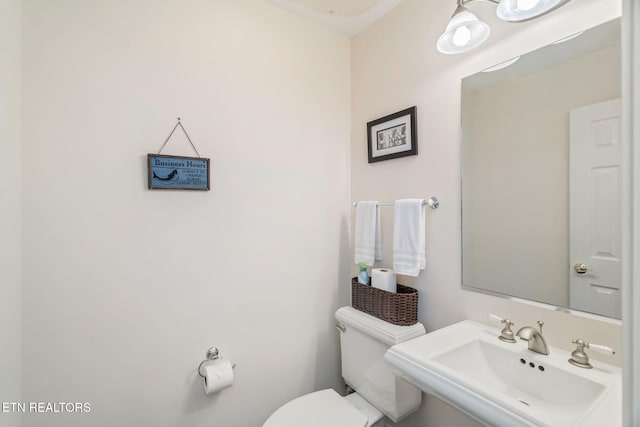 bathroom featuring toilet and sink